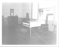 SA0423.7 - Photo showing a Shaker bed and mattress filled with hog hair, a stove, chairs, chests of drawers, and a clock. Identified on the back., Winterthur Shaker Photograph and Post Card Collection 1851 to 1921c